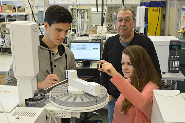 SUNY Oswego students Harry Kandaras (standing) and Justin D’Antonio (second from left) work with high school sophomores Zachary Cronk (left) and Brandon Dobbs in an alternative learning initiative in Wilber Hall.