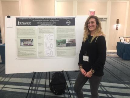 Student Abigail Jago presenting poster at a conference
