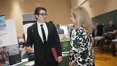 A student talking to an employer at a previous career fair