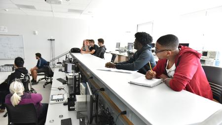 Students sitting in a classroom taking notes