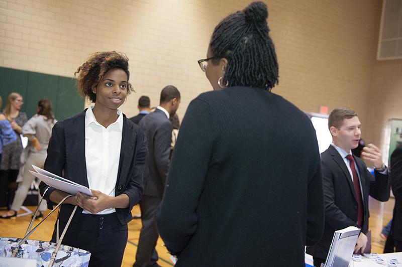 Student speaking with an employer at a career fair