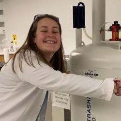 Photo of Olivia with the NMR Instrument