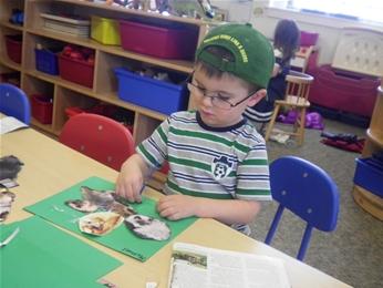 Child being creative at the Children's Center Child gluing paper