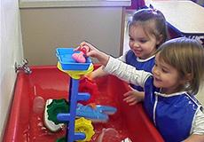 Children playing in water at the Children's Center Children playing in water