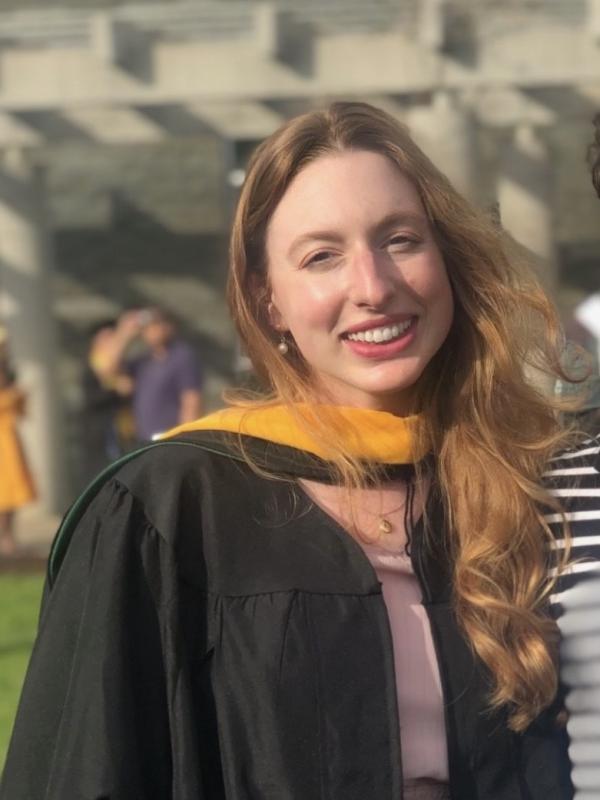 Cat Wells Catherine Wells smiling outside on a sunny day for a Graduation photo