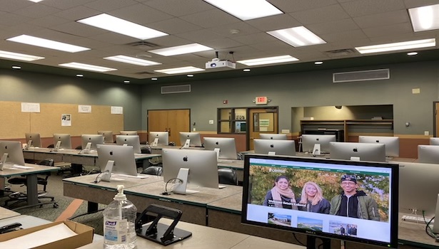 Photo shows the classroom from the podium perspective. Showing the student MAC's and the podium monitor. 