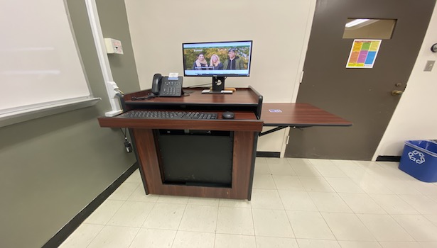 Photo shows the podium in this classroom including the PC and the handicapped side table. 