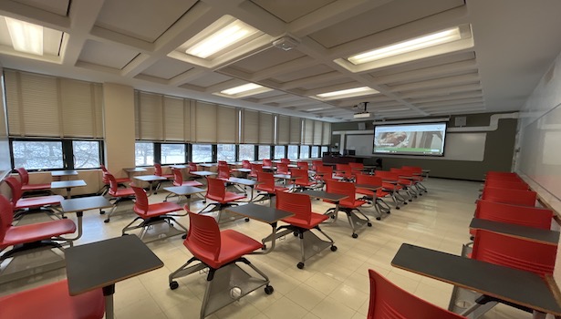 photo from the back of the room to show the entire classroom. including projector screen and student chairs. 