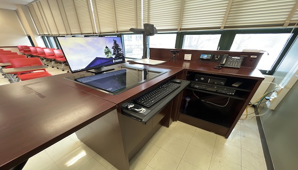 photo of the podium in the room including document camera, PC, DVD/VHS player. 