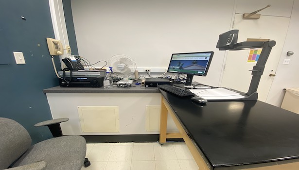 Photo of the podium in the classroom including document camera and PC. 