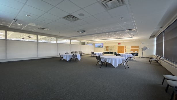 photo shows the classroom from the podium perspective. Showing chairs and the confidence monitor. 