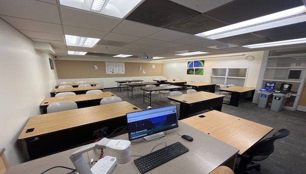 photo of the classroom from the podium perspective. Including student chairs and professor monitor. 