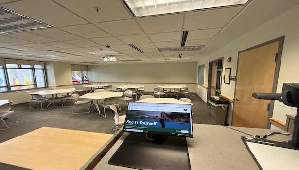 photo shows the classroom from the podium perspective. Showing chairs and the monitor. 