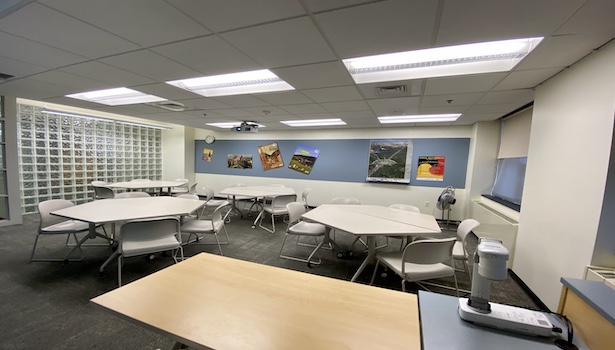 Photo shows the classroom from the podium perspective including chairs and projector. 