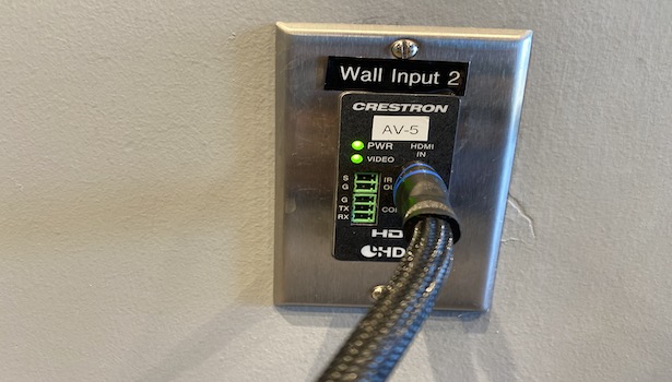Photo shows the wall panel to plug the HDMI Cable for Laptop in (Shown with HDMI Cable plugged in). 