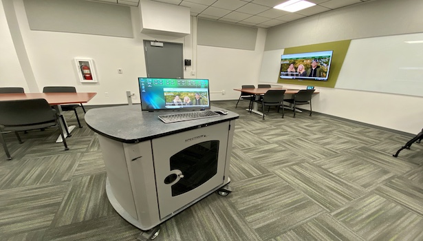 Photo of the professor podium with student equiptment in the background 