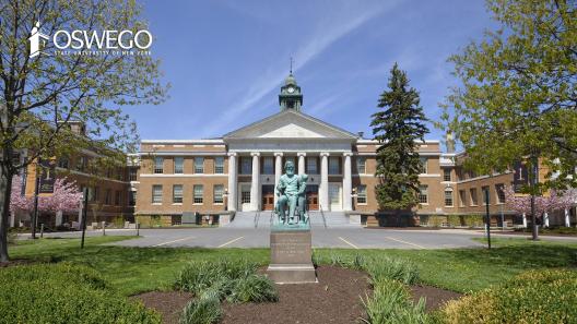 View of front of Sheldon Hall with statue of Edward Sheldon