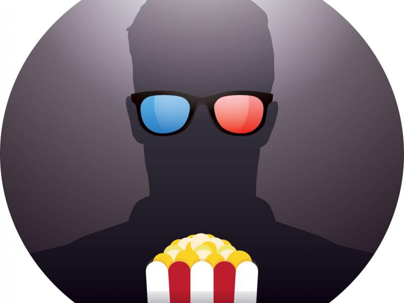 Person with 3d glasses and popcorn watching a film