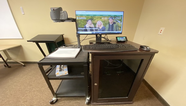 Photo shows the podium in the classroom with the PC, Touch Panel and Document Camera 