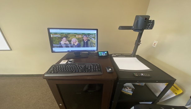 Photo shows the podium in this classroom with the Document Camera PC and Crestron Screen. 