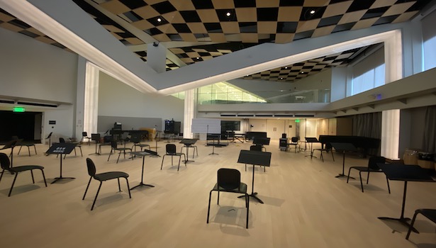 Photo of the classroom from the podium perspective showing chairs and music stands. 