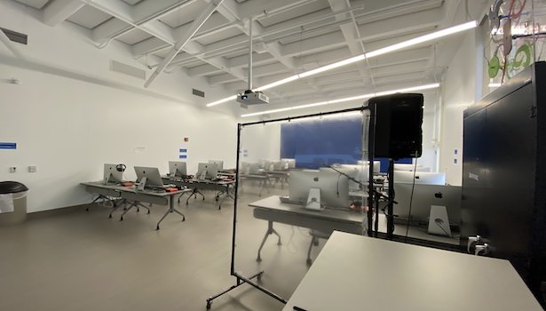 Photo of the classroom from the podium perspective showing student chairs and MAC's 