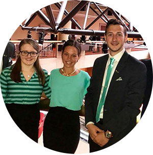 3 students gather and pose at event venue