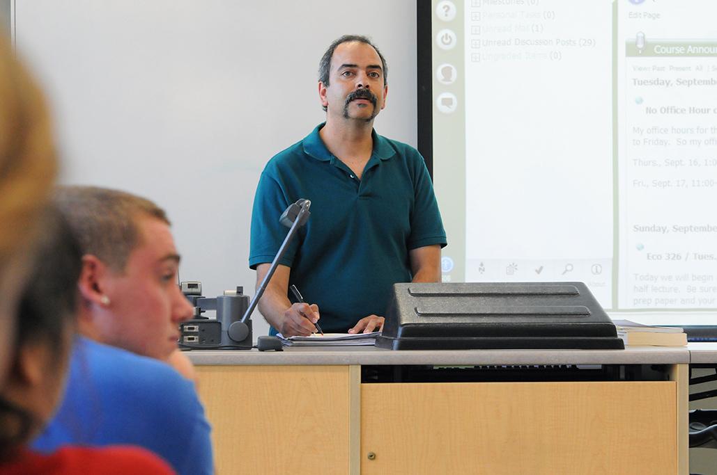 Professor Ranjit Dighe lectures in front of class