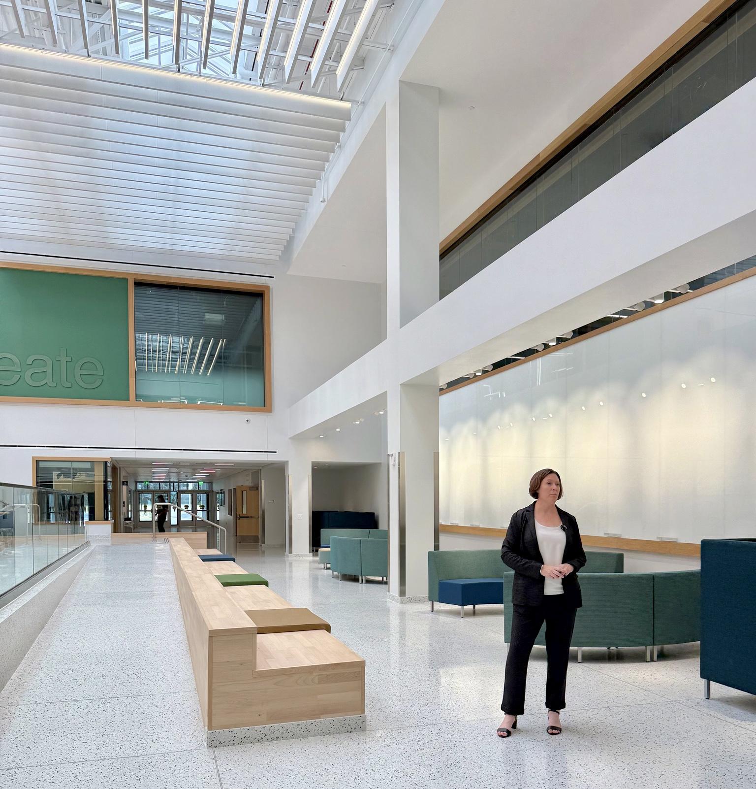 Jennifer Knapp - dean of the College of Communication, Media and the Arts - stands in the Collaborative Core, one of the signature features of the reopened Hewitt Hall