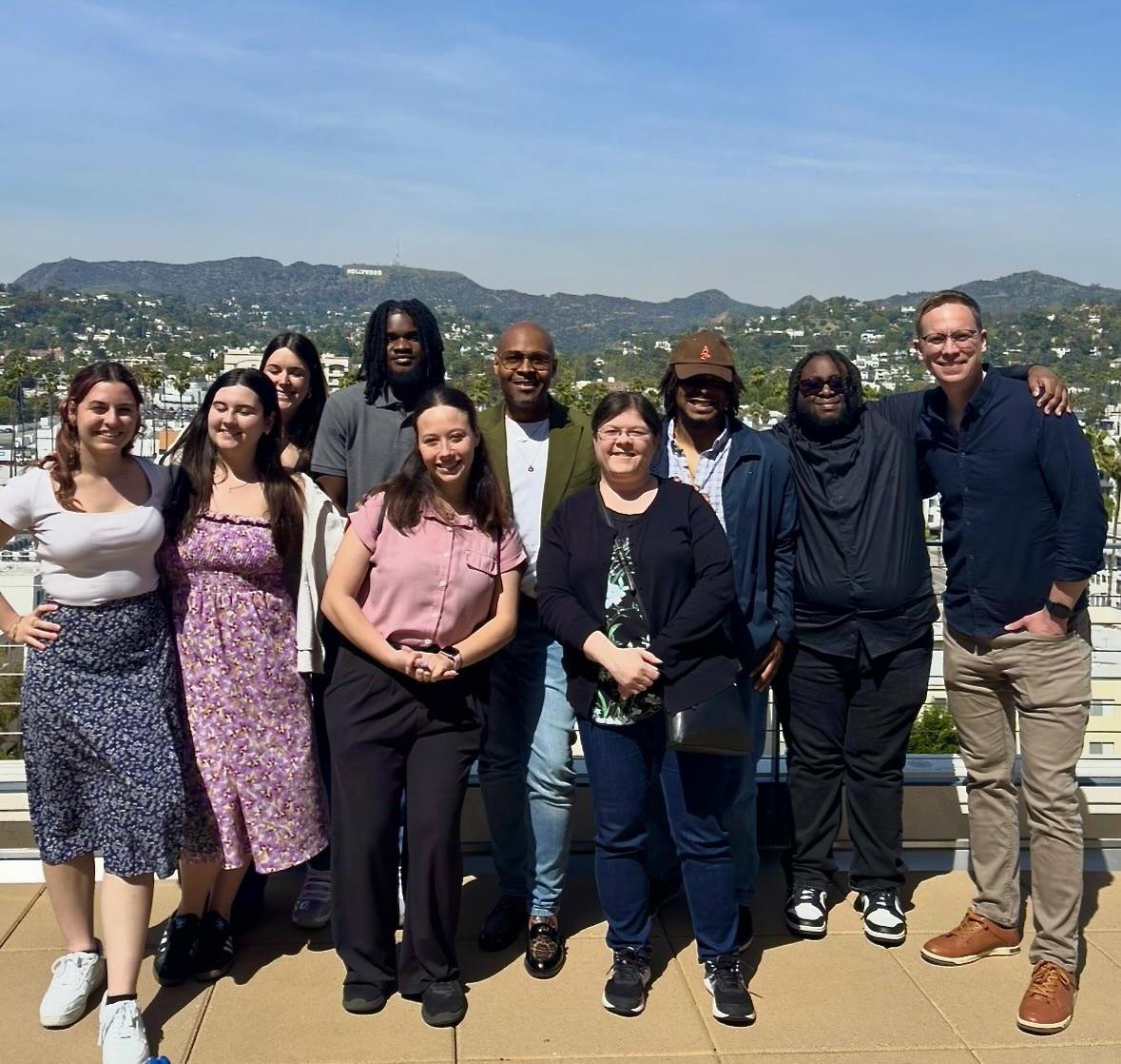 Oswego students and faculty stand in front of the Hollywood sign on their Hollywood POV trip.