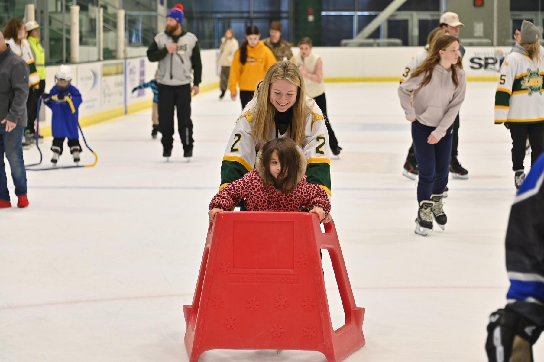 Mack Hall skates with a young Laker fan