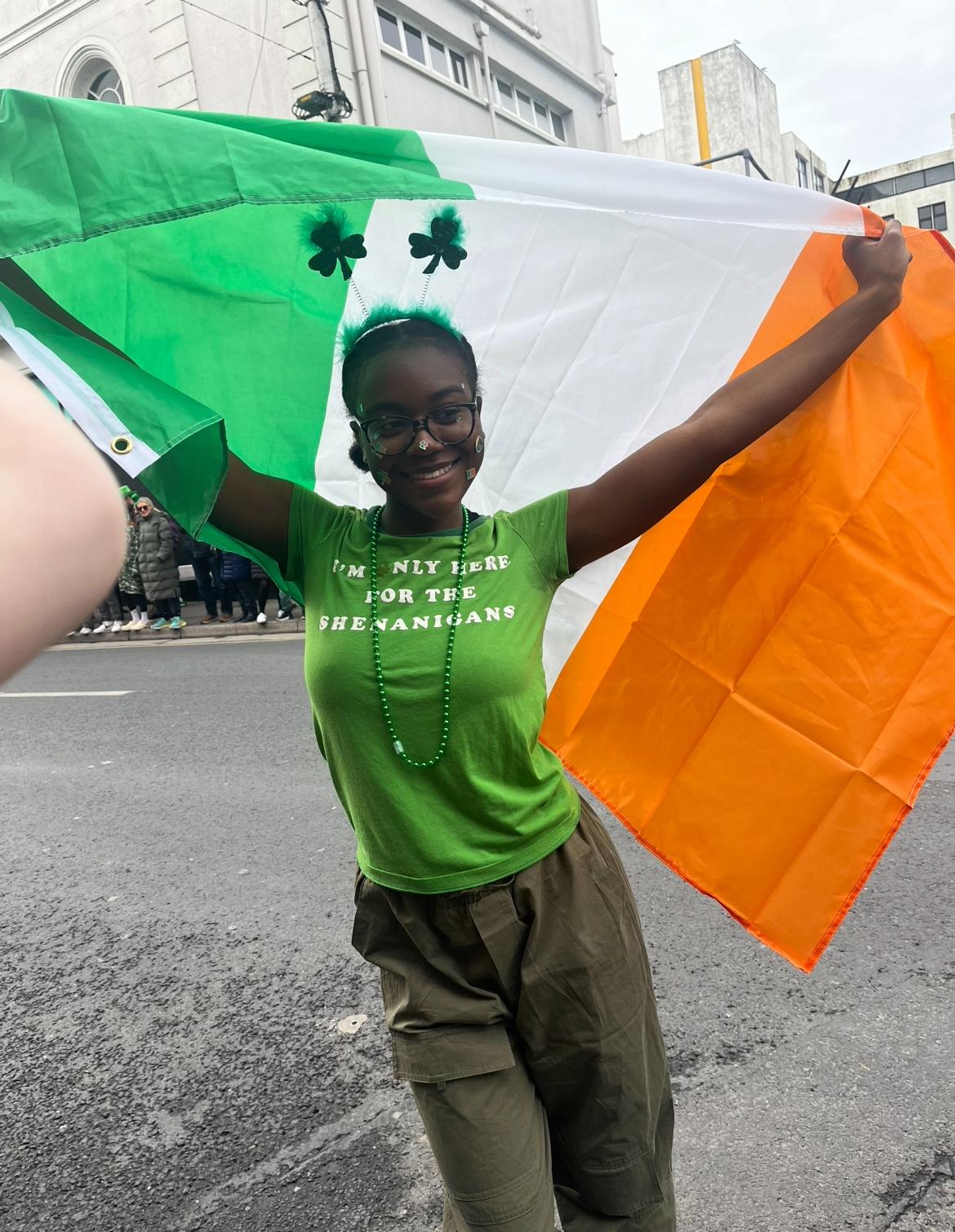 Oswego student Tatienna Samuels dances with the Irish flag in Dublin.
