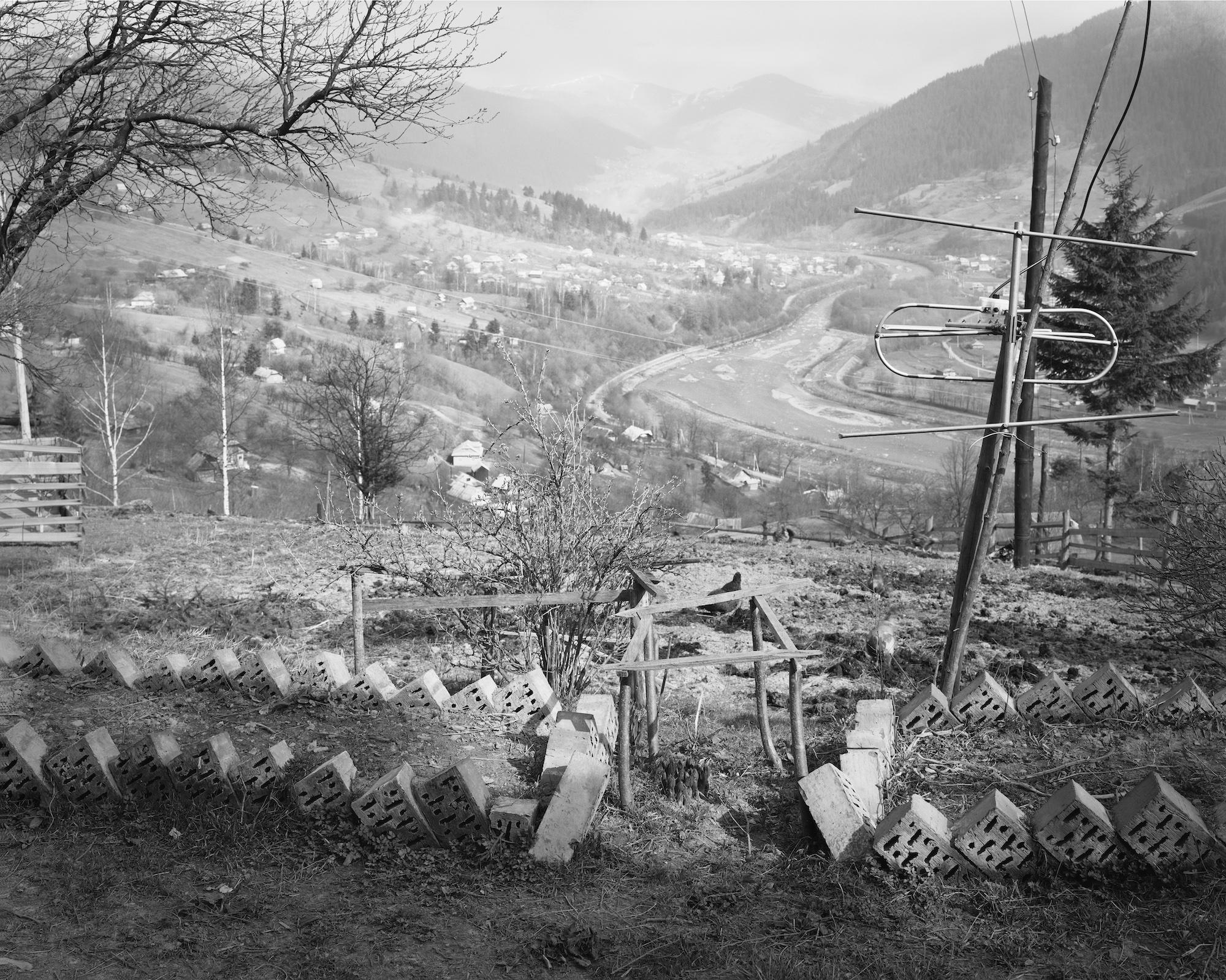 Black and white photo of an antenna upon a hill in Ukraine