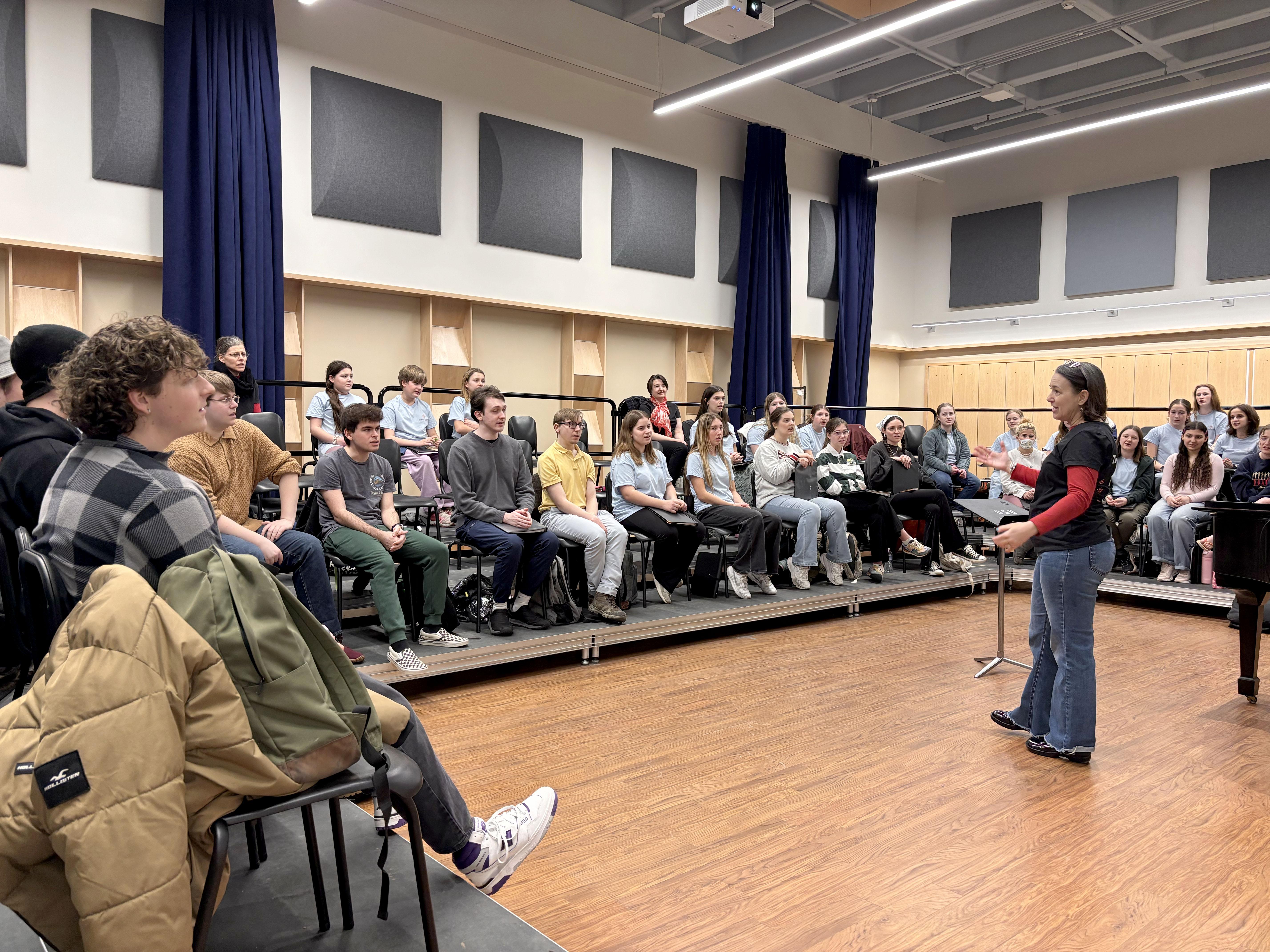 Kathleen Bassett, founder and artistic director for Buffalo GirlChoir, leads a collaboration with SUNY Oswego's State Singers in Tyler Hall