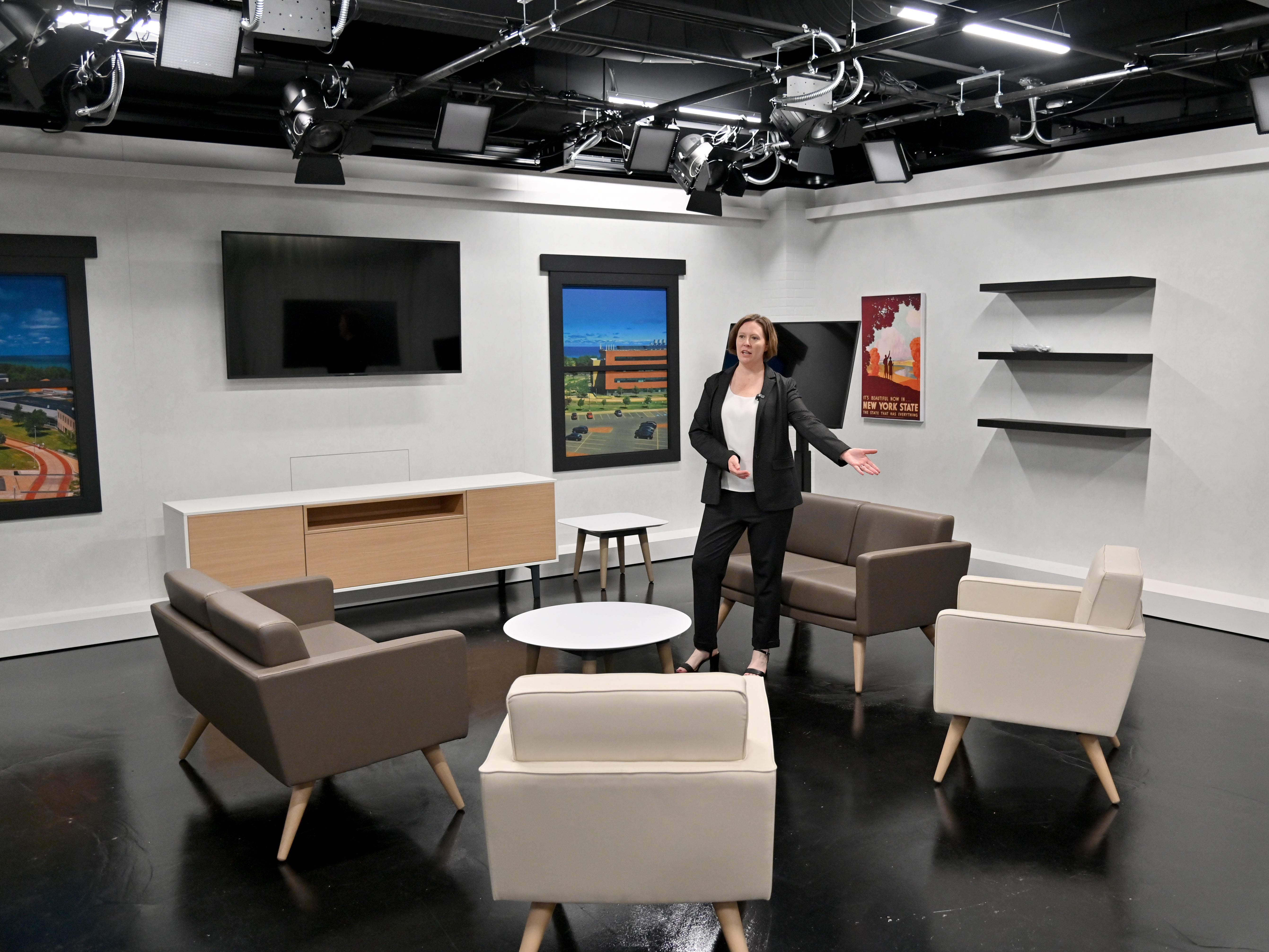 Jennifer Knapp, dean of SUNY Oswego's College of Communication, Media and the Arts, shows off a Hewitt Hall broadcast studio set to visitors just before the start of fall classes.