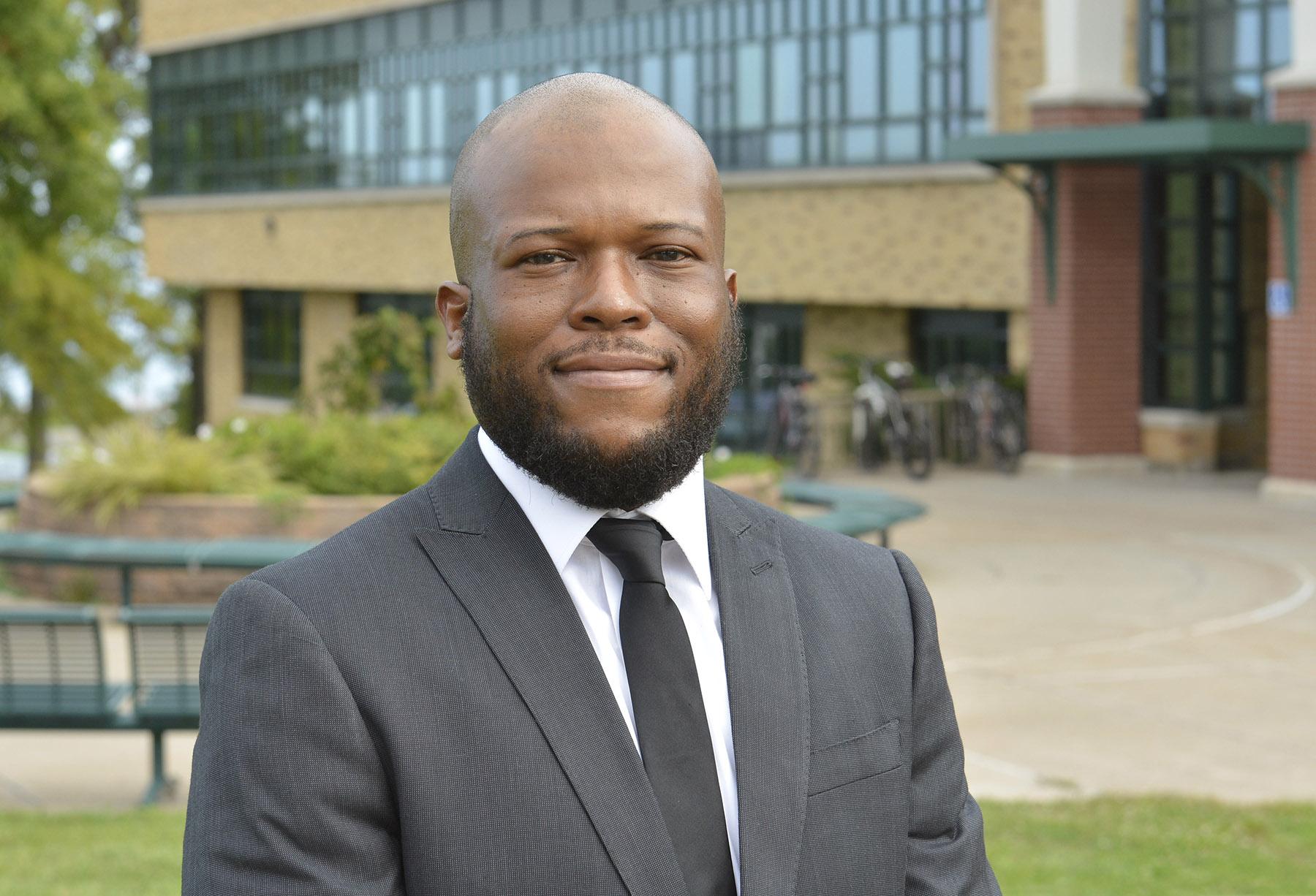 Dr. Isiah Brown stands outside Rich Hall, the college's School of Business