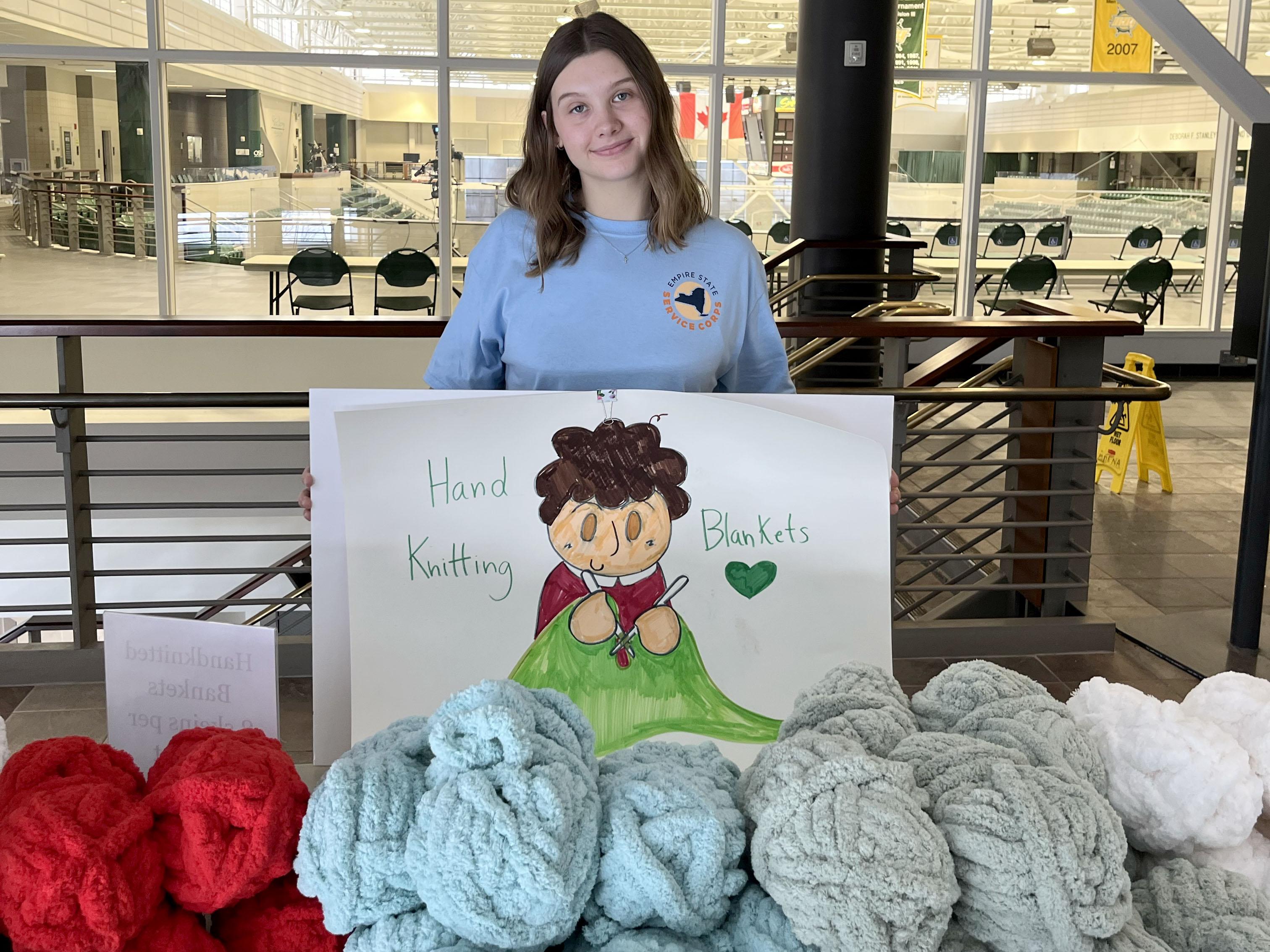 Empire State Service Corps member Arrissa Bunker helps with an opportunity for participants in SUNY Oswego’s 2026 Martin Luther King Jr. Day of Service to knit blankets for community members in need.