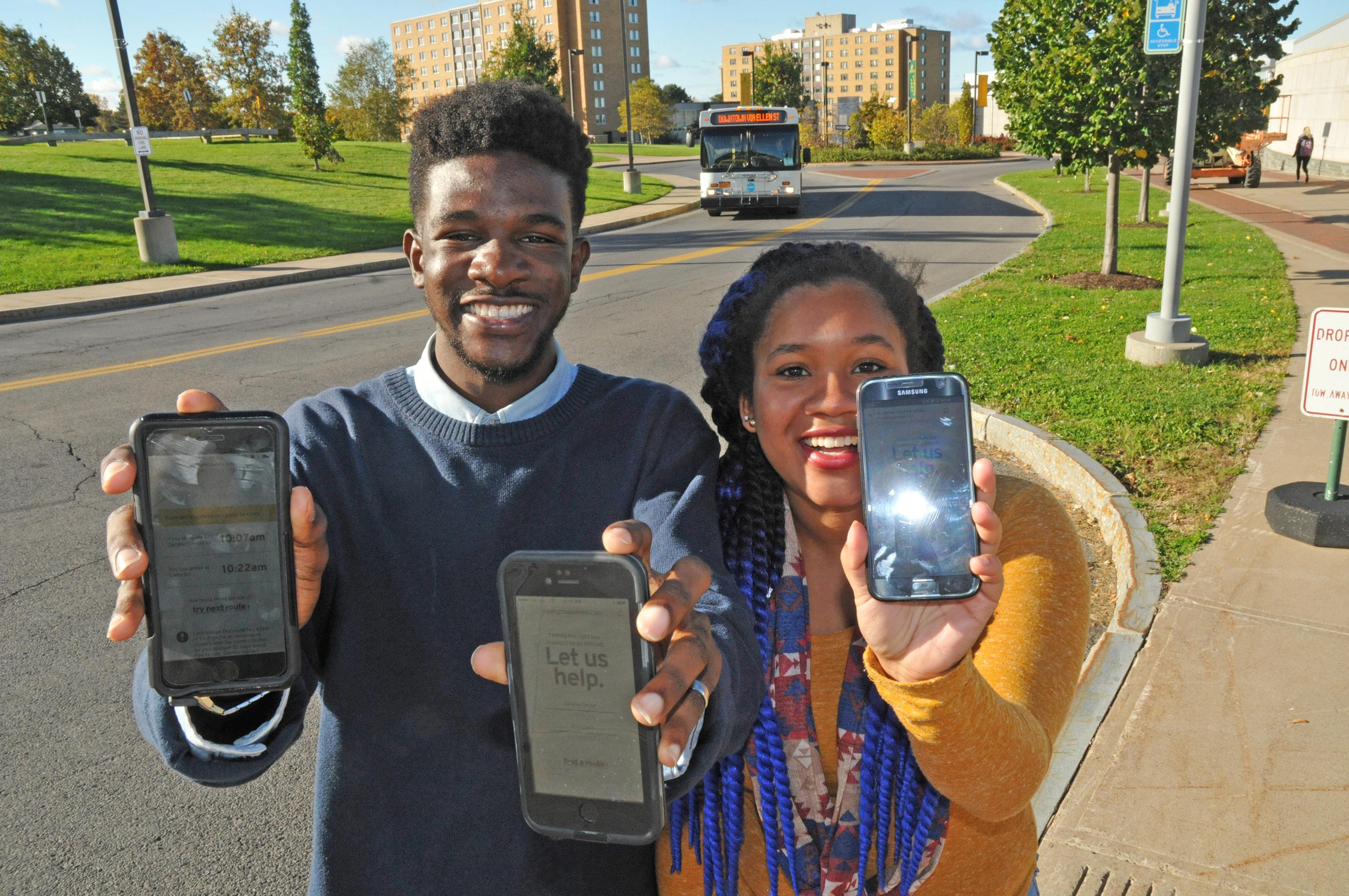 Students show BusShare web app on their smartphones