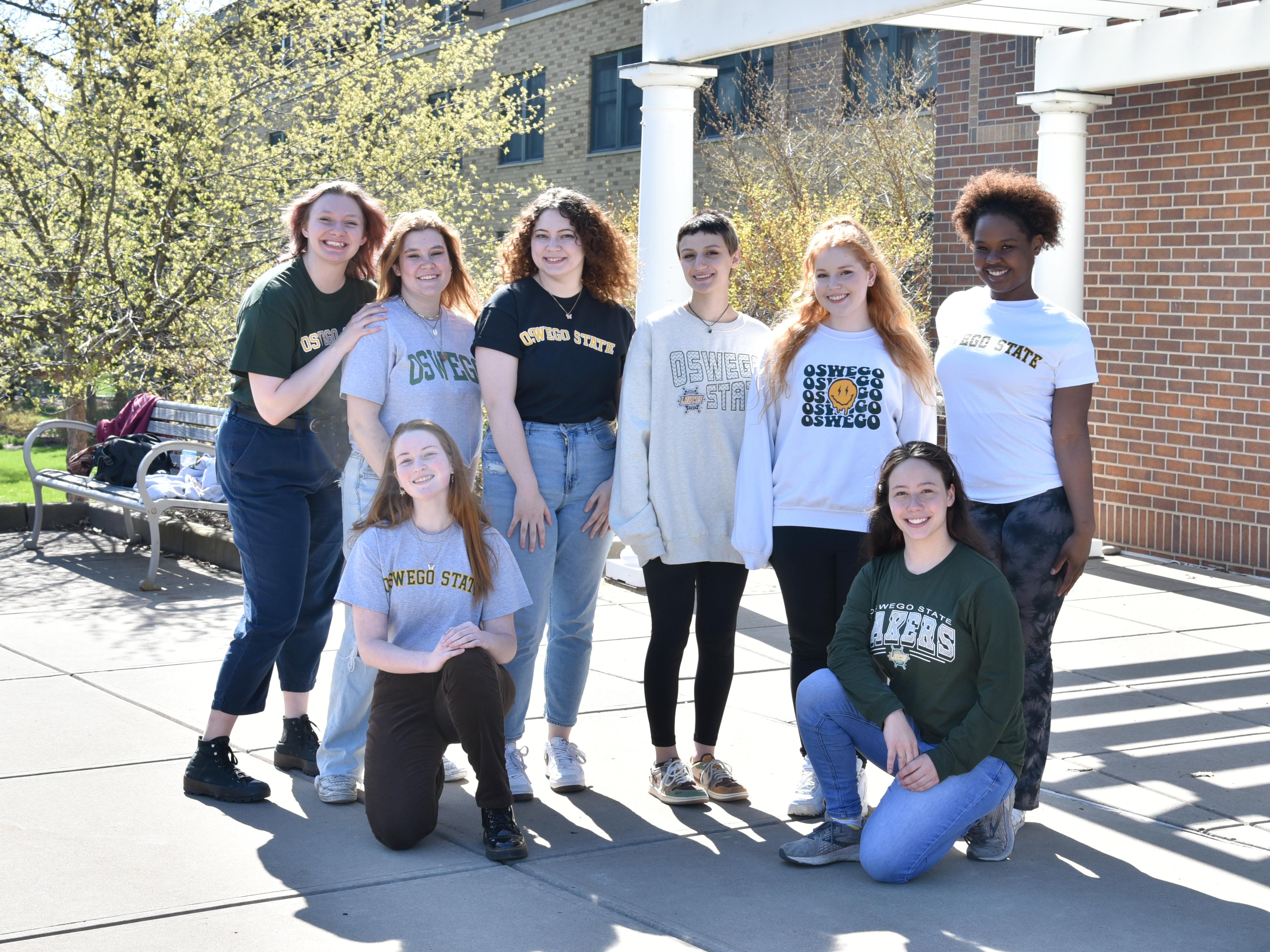 Students pose for a photo on the lakeside part of campus