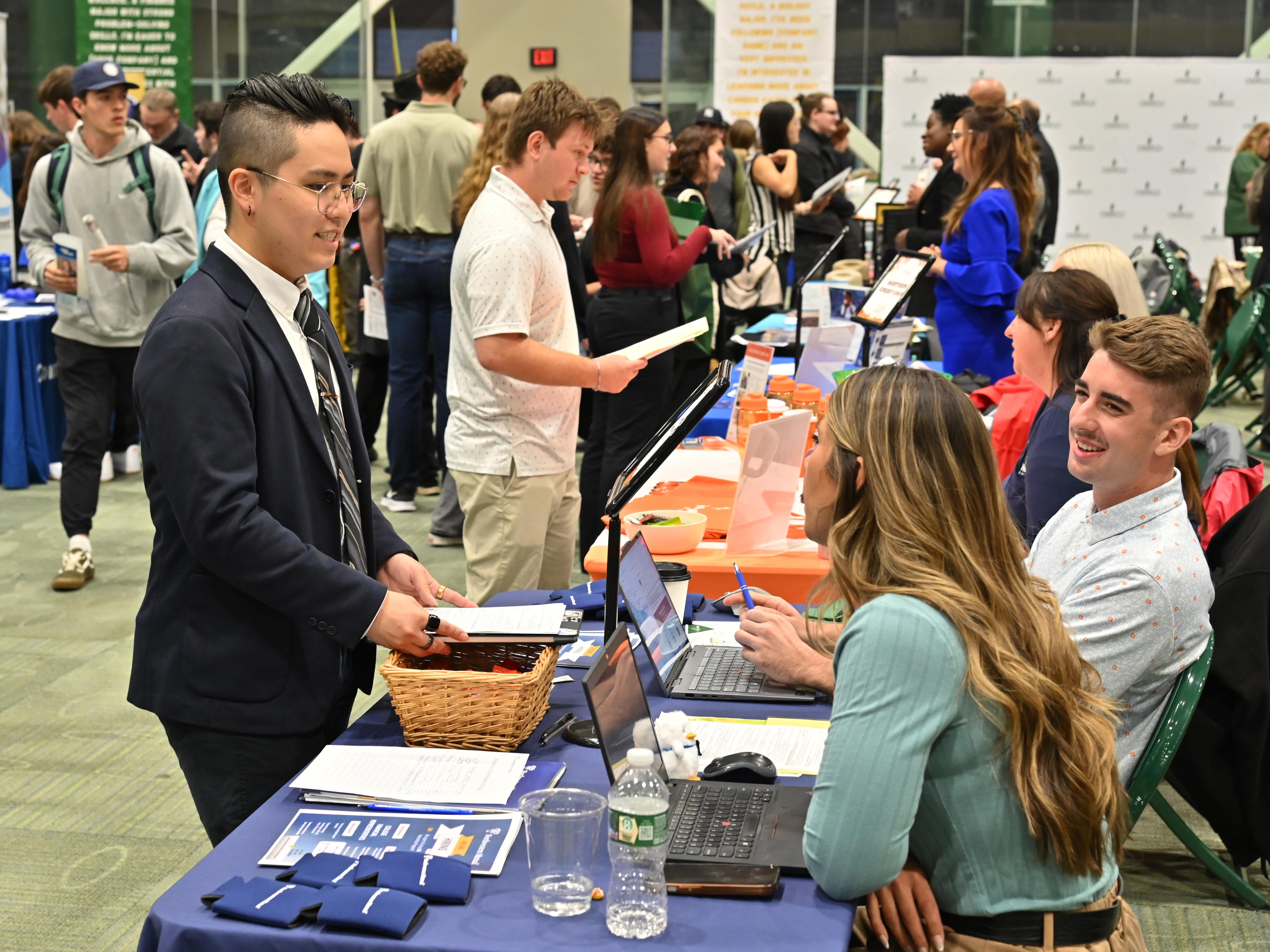 Students interact with employees at a previous career fair