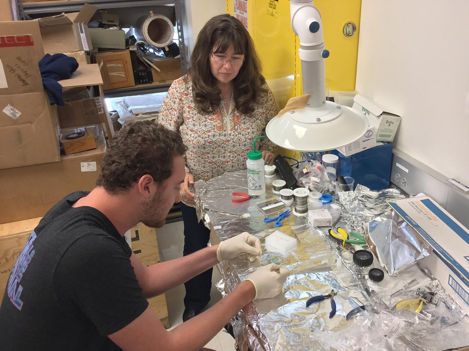 Carolina Ilie works with student Dylan Richmond in a physics lab