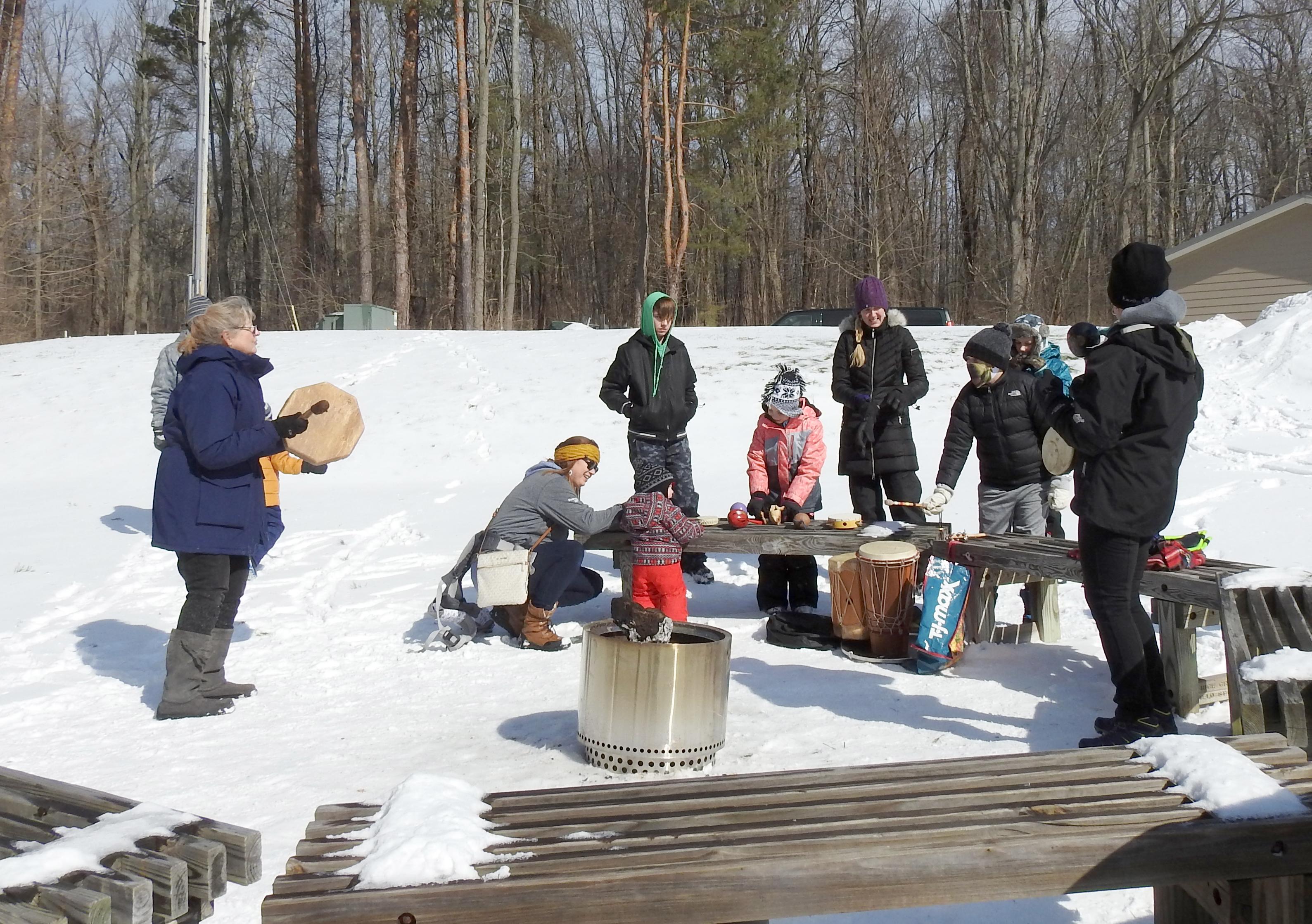 Rice Creek Field Station naturalist Linda Knowles leads a percussion circle by the campfire