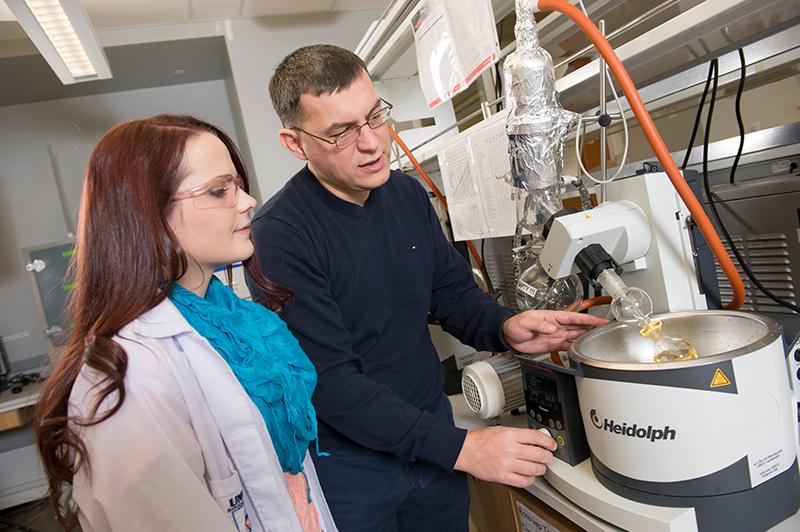 Chemistry professor, Fehmi Damkaci in lab with student