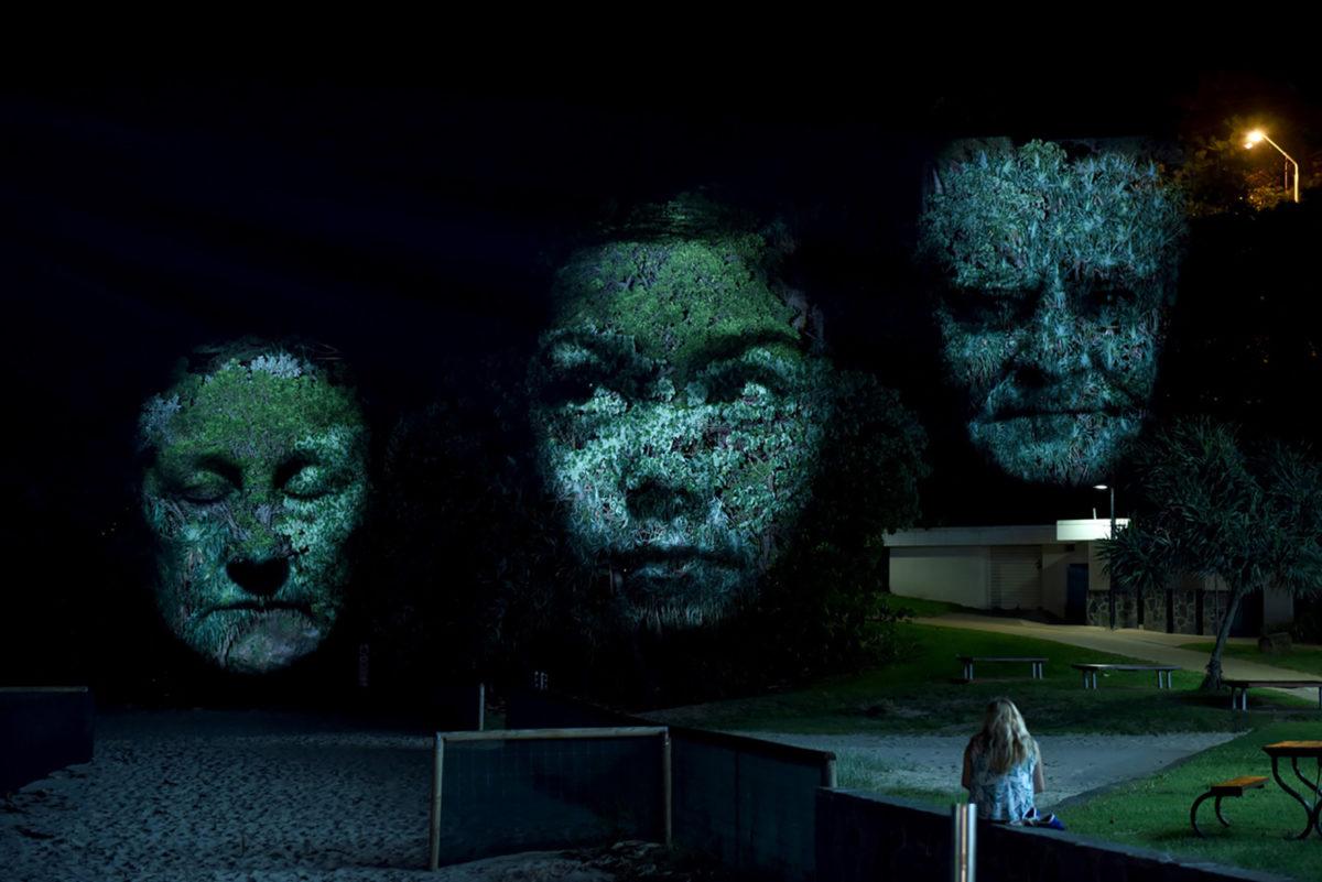 Project visual art of three faces by Craig Walsh at a previous installation in Australia