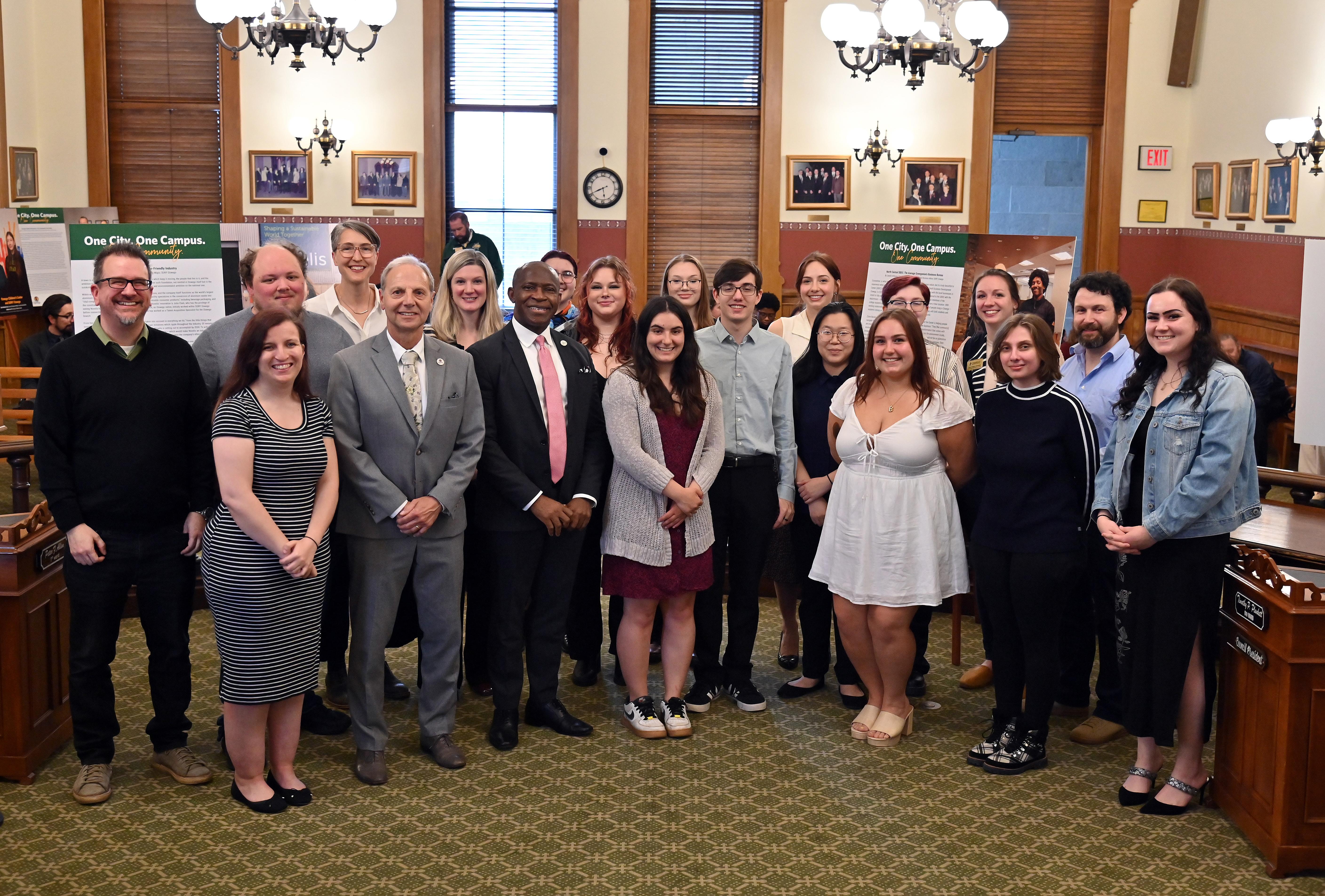 Representations of the City of Oswego and SUNY Oswego gather for an opening reception for the One City. One Campus. One Community. photojournalism project