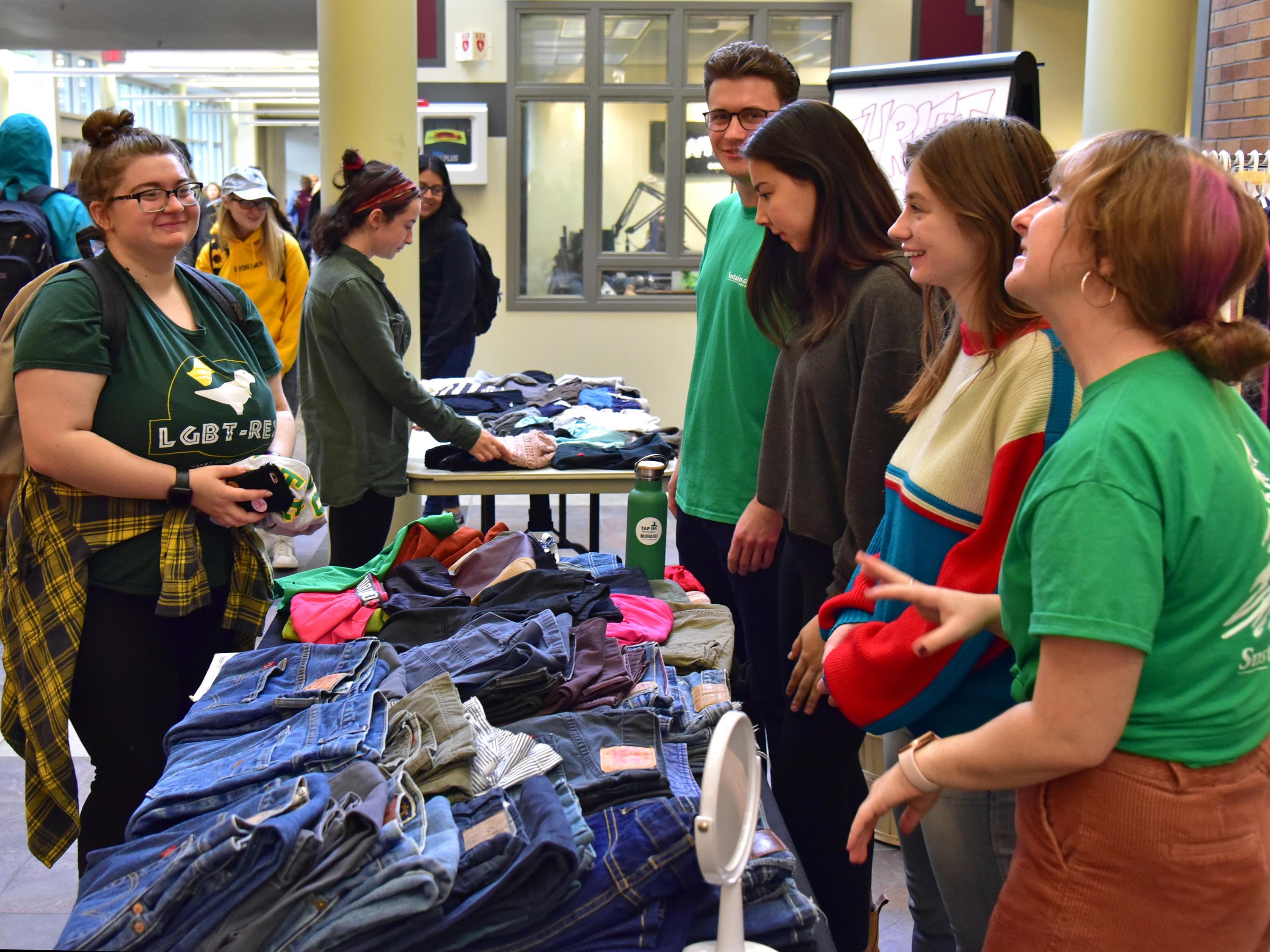 Students buying and working the table for a thrift sale