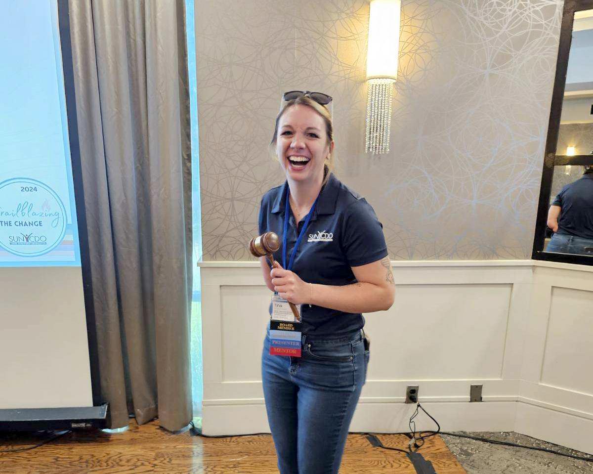Tina Cooper holds a gavel after being elected SUNY CDO president