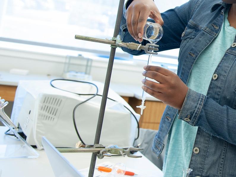 Student pouring in a chemistry lab