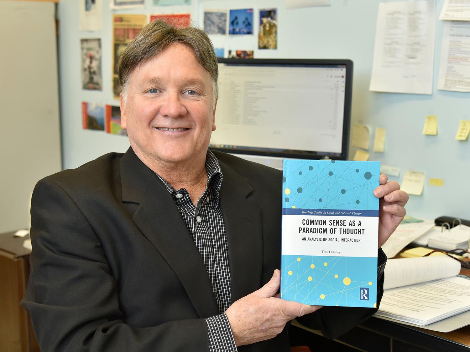 Tim Delaney with book, Common Sense as a Paradigm of Thought