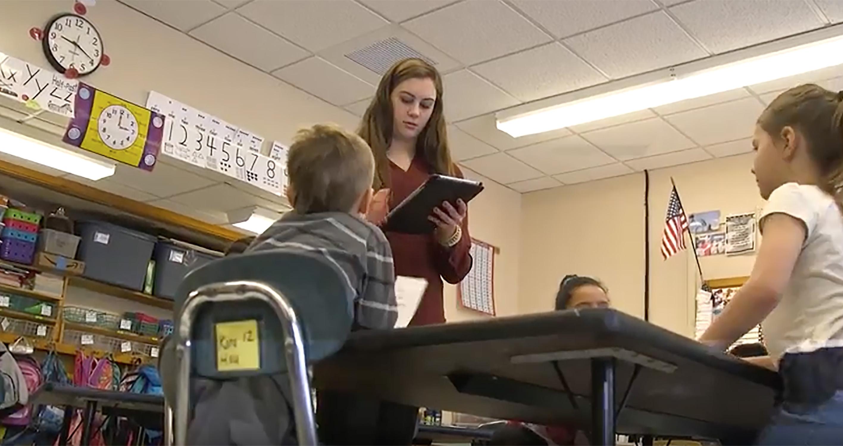 Student teacher works with schoolchildren